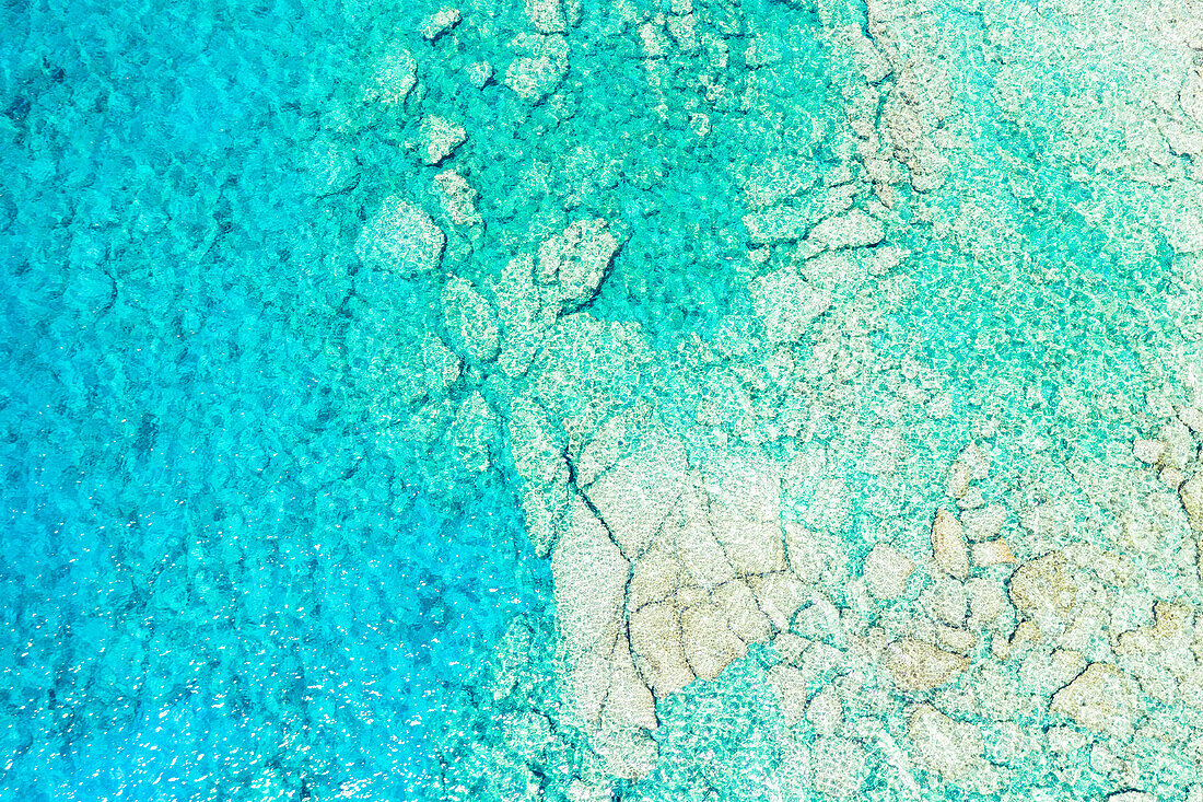 Rocks in the turquoise lagoon from above, aerial view, Crete island, Greece