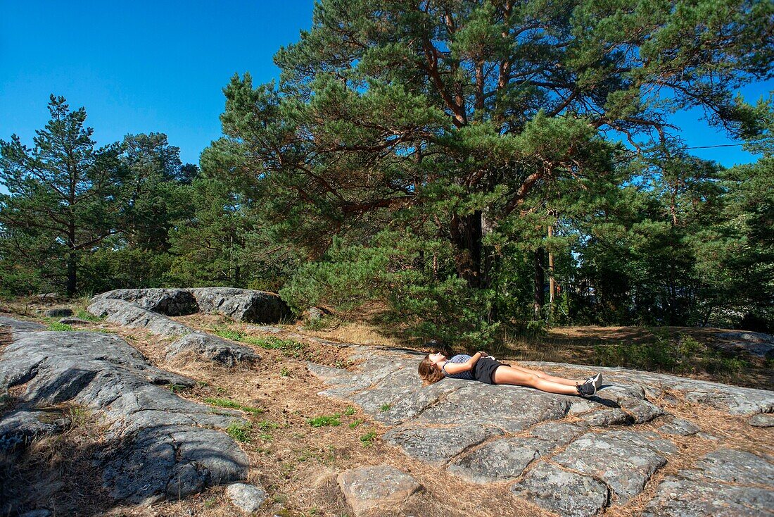 Girl resting at Mossala Island Resort Southwest Finland archipelago. The archipelago ring road or Saariston rengastie is full of things to see, do and do. The Archipelago Trail can be taken clockwise or counter clockwise, starting in the historical city of Turku, and continuing through rural archipelago villages and astonishing Baltic Sea sceneries. The Trail can be taken from the beginning of June until the end of August.