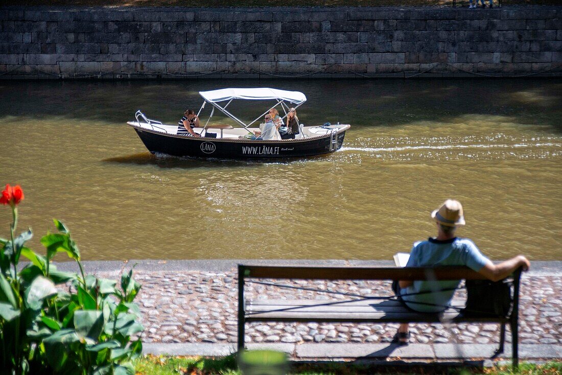 Family in electric boats for rent in the River Aura in Turku Finland.