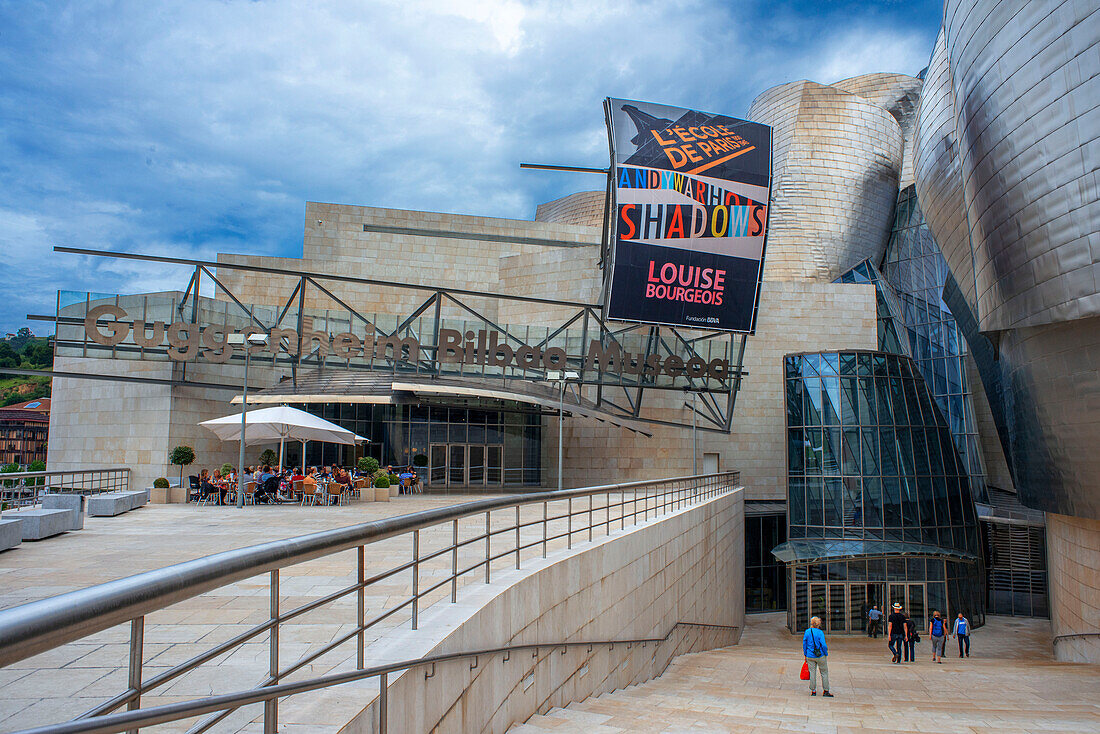 Der Eingang des Guggenheim-Museums in Bilbao spiegelt sich im Fluss Nervion, Bilbao, Baskenland, Spanien