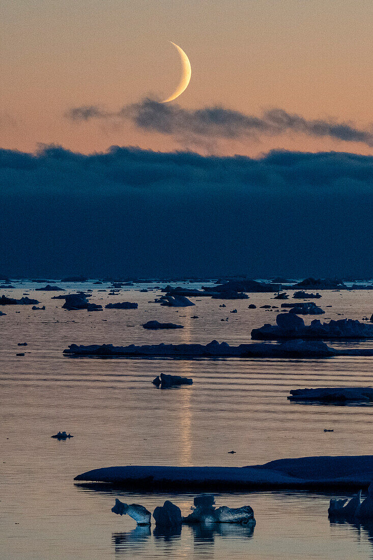 Moonrise at dusk in the Weddell Sea, Antarctica.