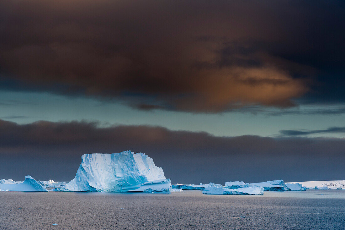 Icebergs under a stormy sky, Lemaire channel, Antarctica. Antarctica.
