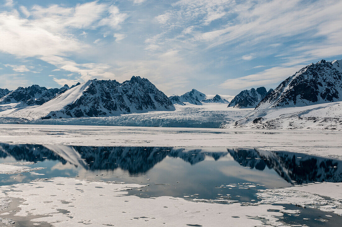 Monaco Glacier and its mirror reflection on arctic waters. Monaco Glacier, Spitsbergen Island, Svalbard, Norway.