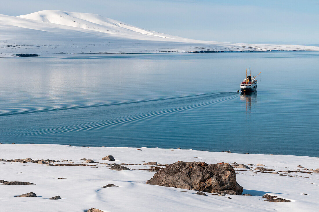 An expedition cruise ship anchors in Bockfjorden. Bockfjorden, Spitsbergen Island, Svalbard, Norway.