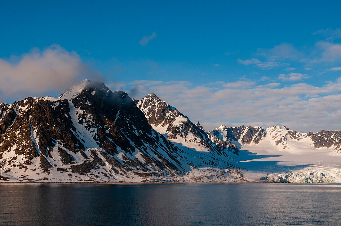 A scenic view of ice covered mountains surrounding Magdalenefjorden. Magdalenafjorden, Spitsbergen Island, Svalbard, Norway.