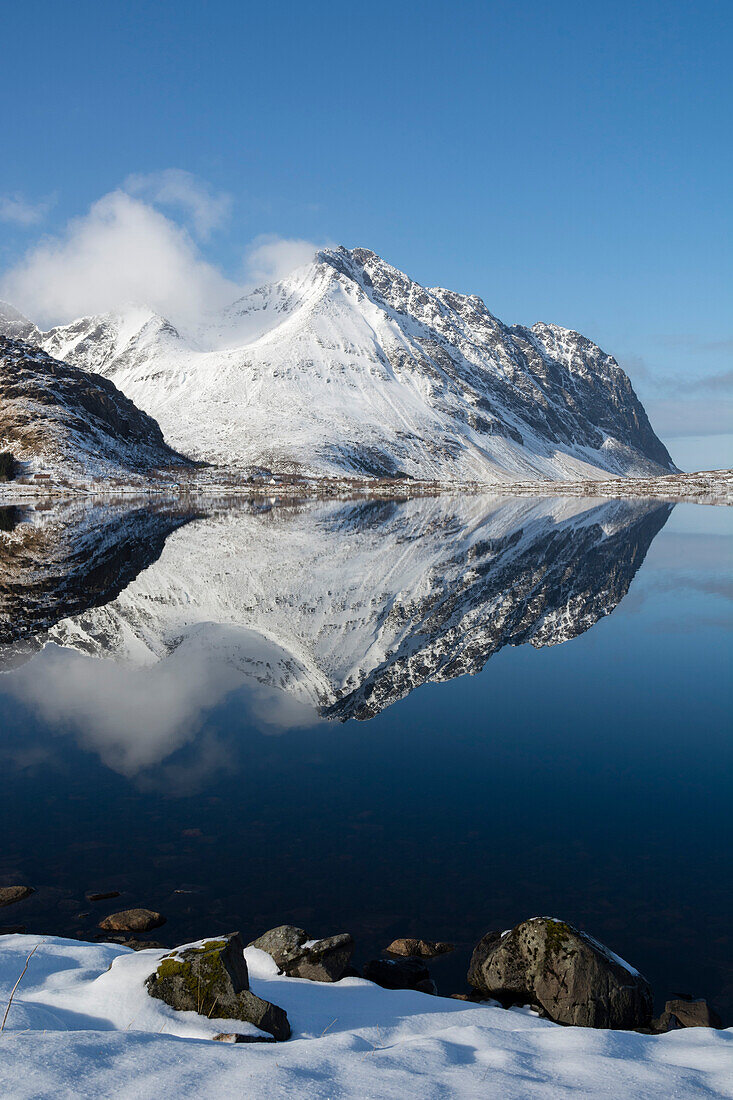 Mountains reflected into the calm water of a lake. Eggum, Lofoten Islands, Nordland, Norway.
