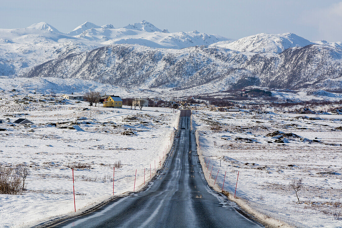 The National Tourist Road, Lofoten, through a snowy and mountainous landscape. Vestvagoy, Lofoten Islands, Nordland, Norway.