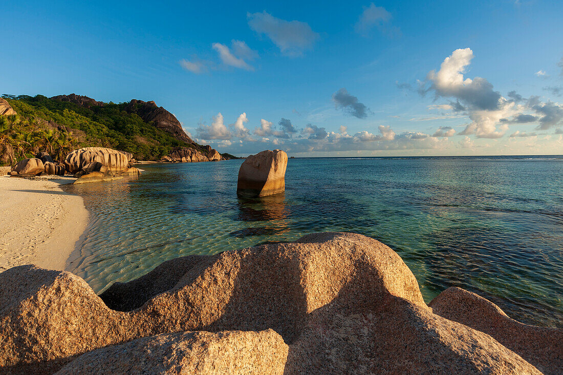 Rock formations and sandy beach on a tropical island in the Indian Ocean. Anse Source d'Argent Beach, La Digue Island, The Republic of the Seychelles.