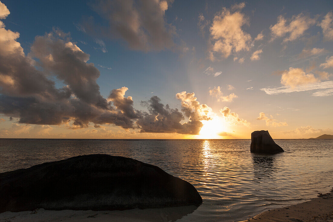 The Indian Ocean off the coast of the Anse Source d'Argent beach, at sunset. Anse Source d'Argent Beach, La Digue Island, The Republic of the Seychelles.