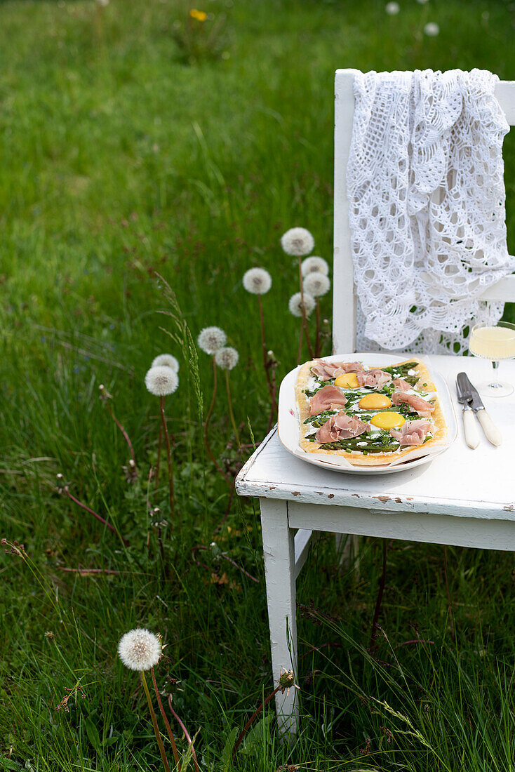 Asparagus tart with goat cheese, herbs, eggs and prosciutto