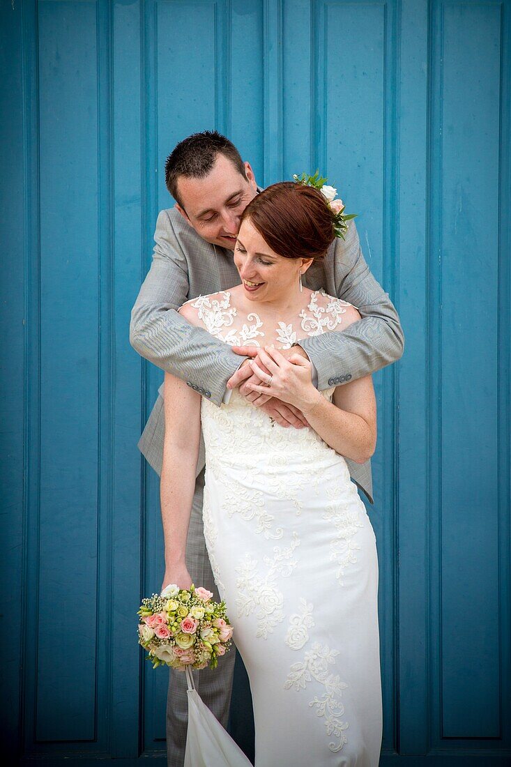 The young married couple posing for the photographer, wedding day