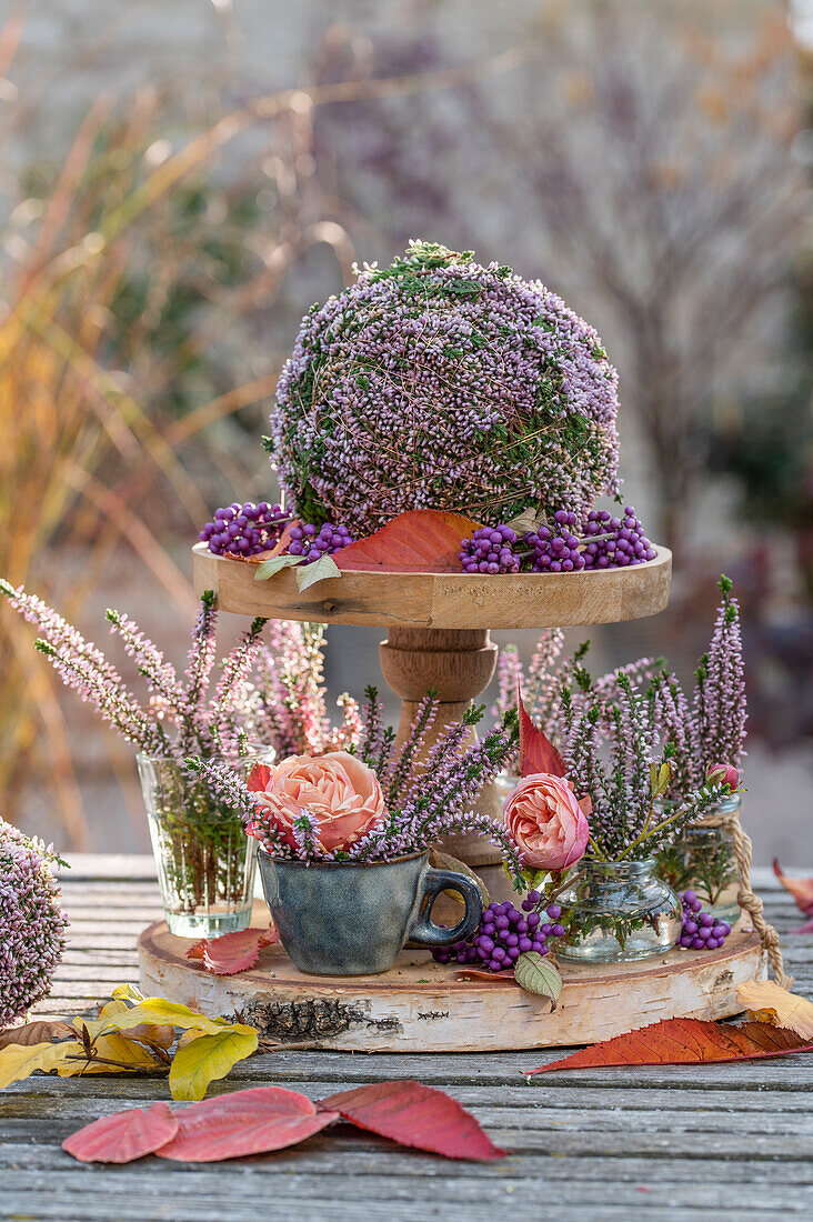 Autumnal flower arrangements of roses (Rosa) and heather (Calluna vulgaris) in ball form