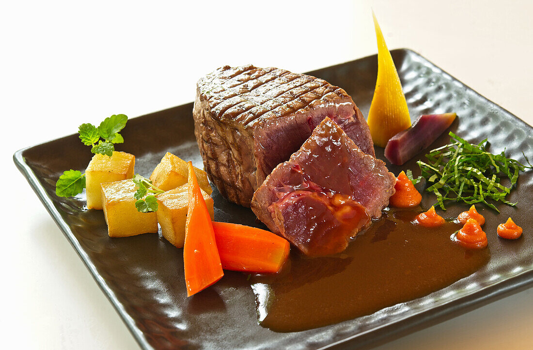 Grilled ostrich fillet with carrots and potatoes