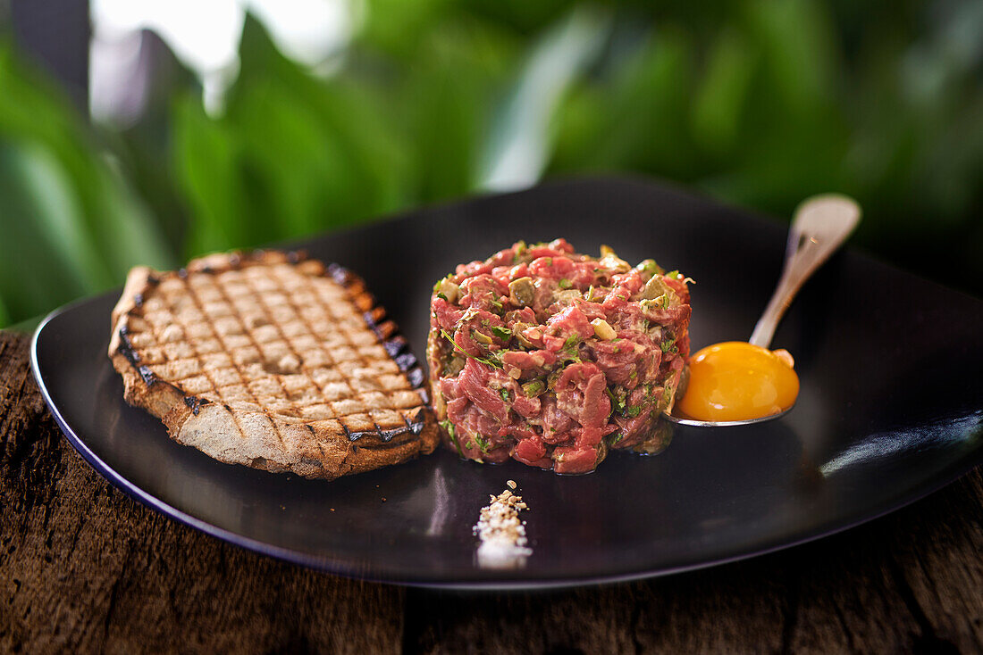 Beef tartare with egg yolk and toasted bread