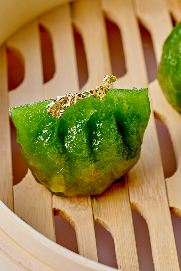 Green vegetable dim sum with gold leaf
