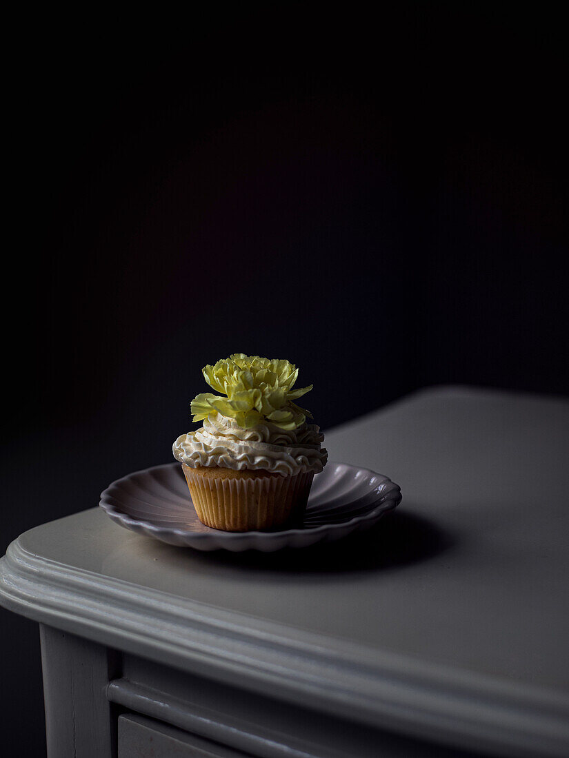 Cupcakes with lemon curd, buttercream and flower decoration