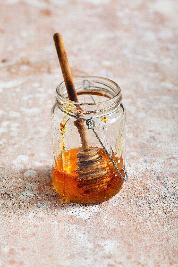Honey and honey dipper in glass