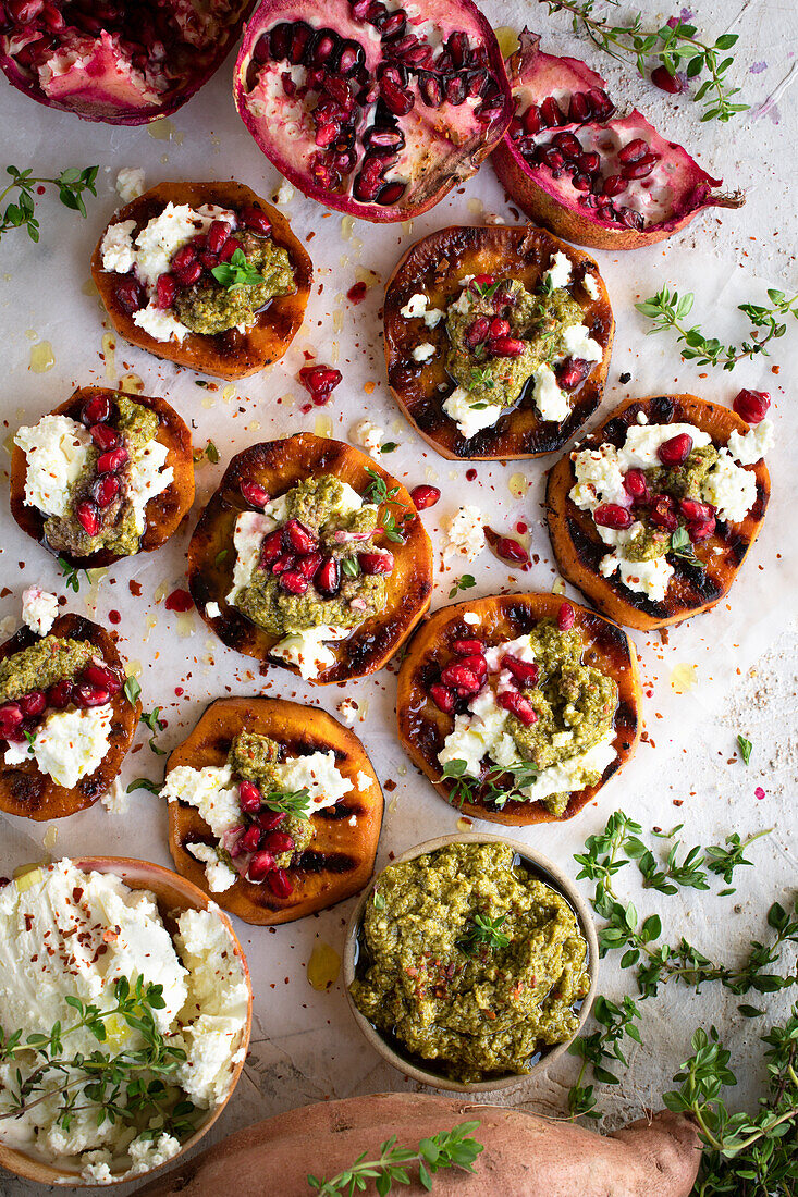 Sweet potatoes with pomegranate, feta and green pesto