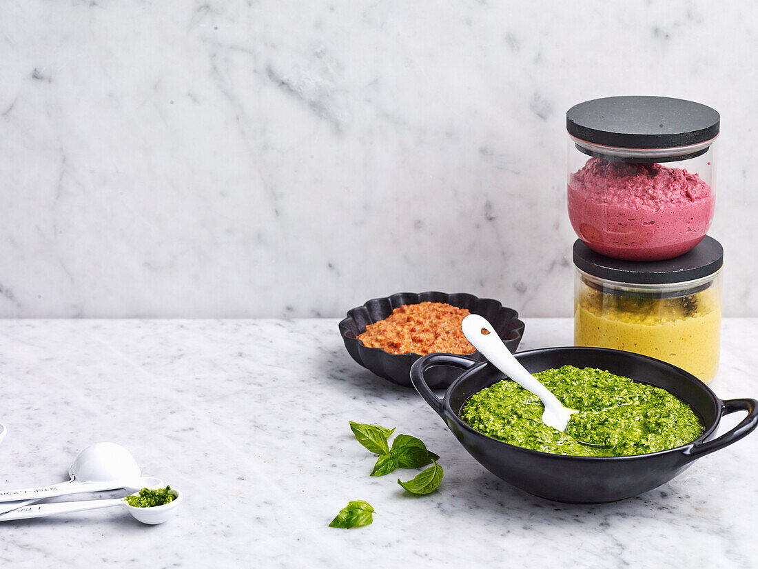 Vegeterian sauces - carrot cumin hummus, green pesto, beetroot hummus, Muhammara dip