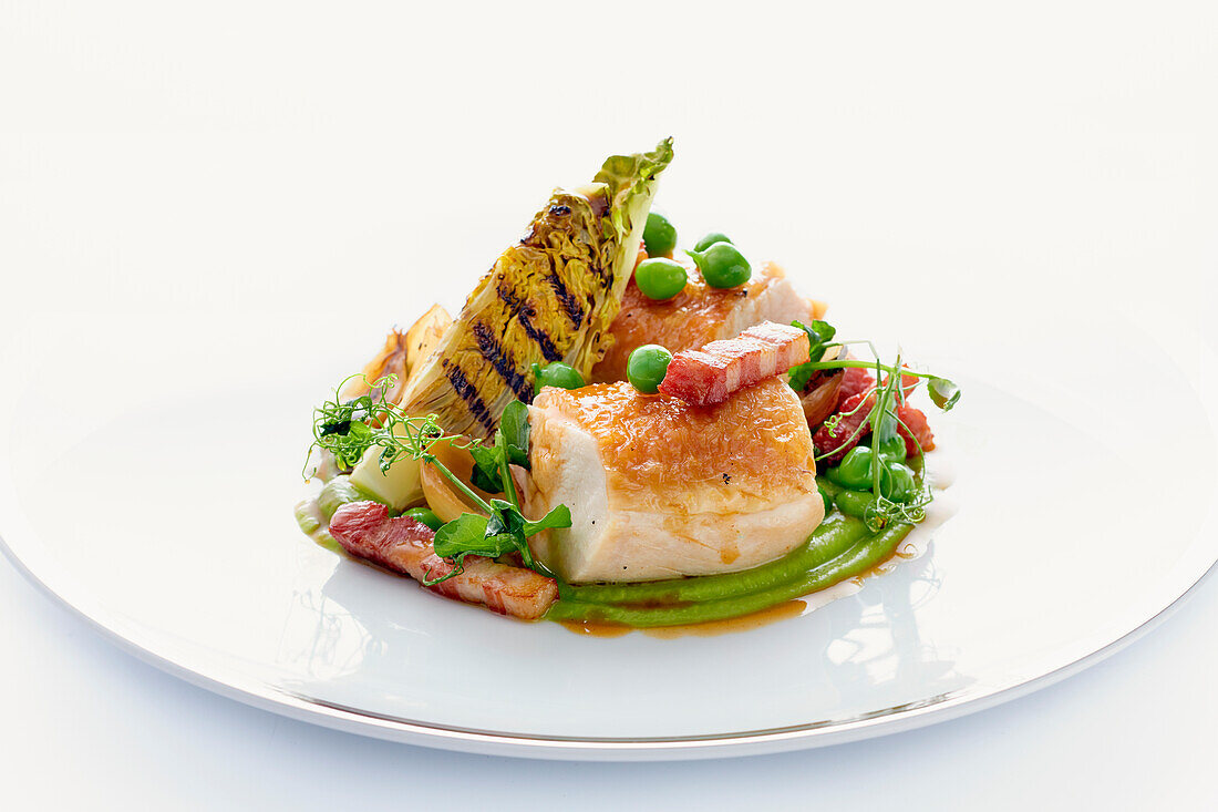 Chicken breast with grilled lettuce, peas and bacon