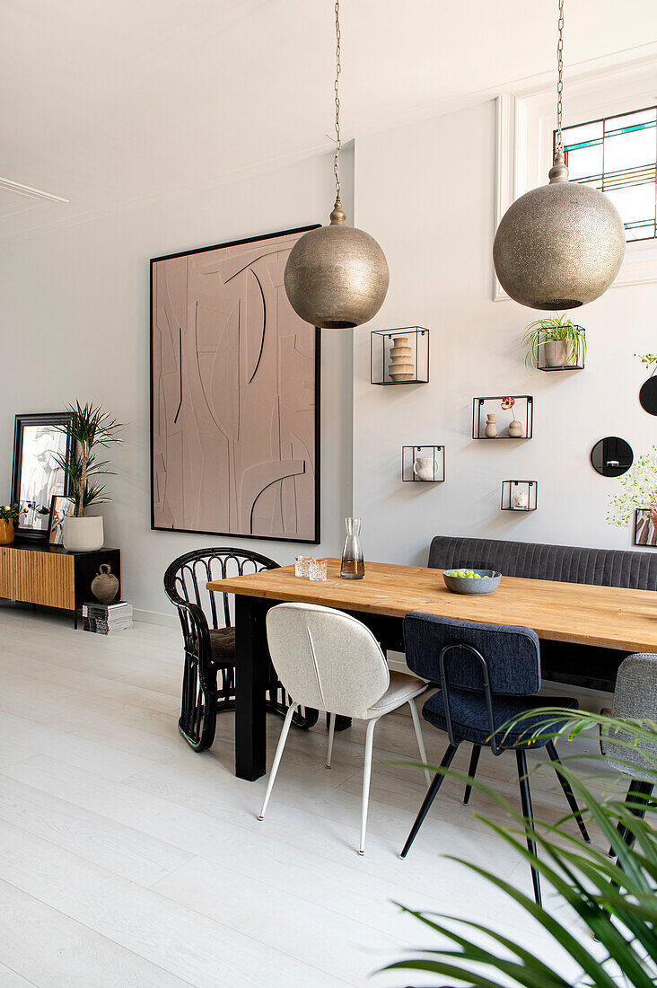 Dining area with artwork and decorative objects on a white wall