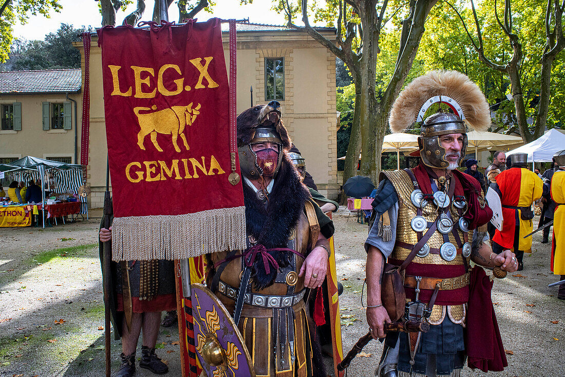 Wie eine römische Legion gekleidete Menschen in Pont du Gard, Region Languedoc-Roussillon, Frankreich, Unesco-Weltkulturerbe. Das römische Aquädukt überquert den Fluss Gardon in der Nähe von Vers-Pon-du-Gard im Languedoc-Roussillon mit 2000 Jahre alten