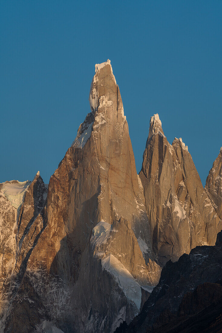 Cerro Torre with its permanent cap of snow and ice. To the right are Cerro Egger and Punta Herron. Los Glaciares National Park near El Chalten, Argentina. A UNESCO World Heritage Site in the Patagonia region of South America.