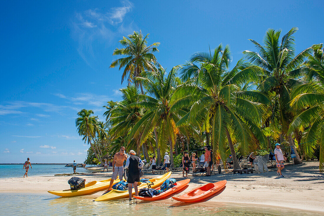 Kayaking in Taha'a island beach, French Polynesia. Motu Mahana palm trees at the beach, Taha'a, Society Islands, French Polynesia, South Pacific.