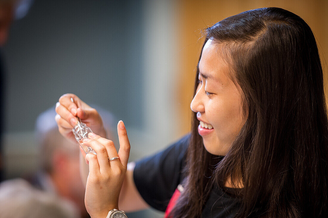 Asian woman using tweezers in a science lab in College Park, Maryland, USA