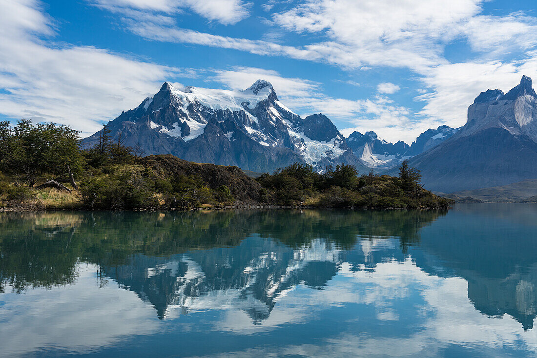 Early morning reflections of the Paine Massif in Lago Pehoe in Torres del Paine National Park, a UNESCO World Biosphere Reserve in Chile in the Patagonia region of South America.