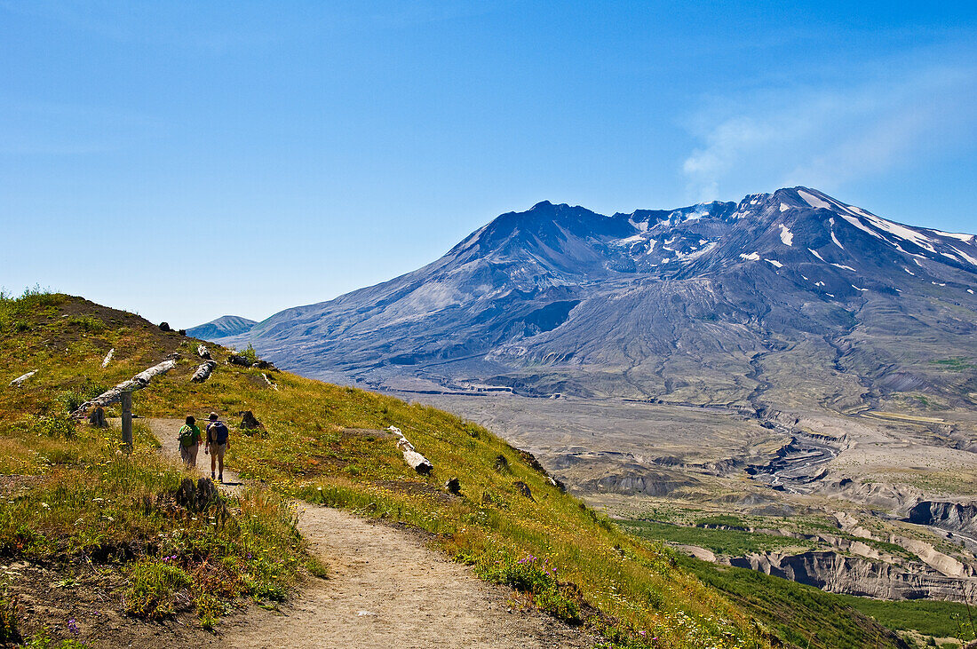 Two women hiking on Boundary Trail near Johnston Ridge Visitor Center; Mount Saint Helens National Volcanic Monument, Washington.