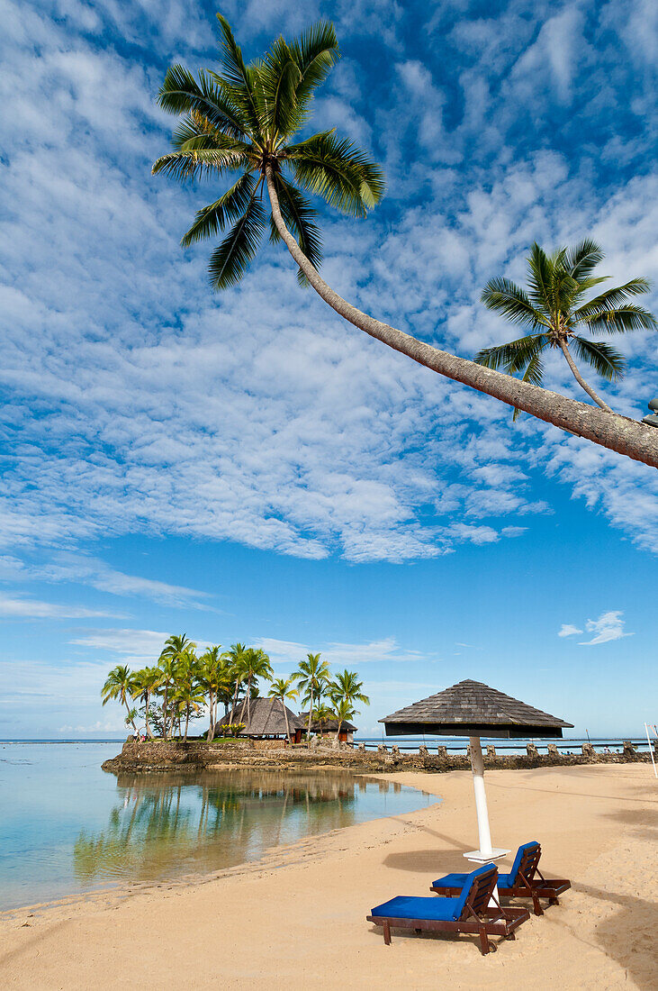 Beach, palm trees and Wicked Walu Restaurant at Warwick Fiji Resort & Spa, Coral Coast, Viti Levu Island, Fiji.