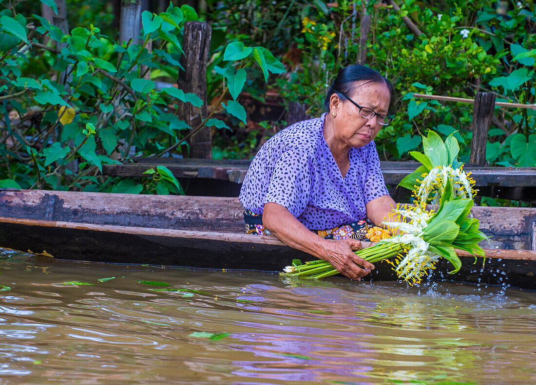 Intha woman on her boat in Inle lake Myanmar