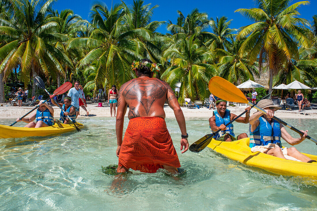 Kajakfahren am Strand der Insel Taha'a, Französisch-Polynesien. Motu Mahana Palmen am Strand, Taha'a, Gesellschaftsinseln, Französisch-Polynesien, Südpazifik.