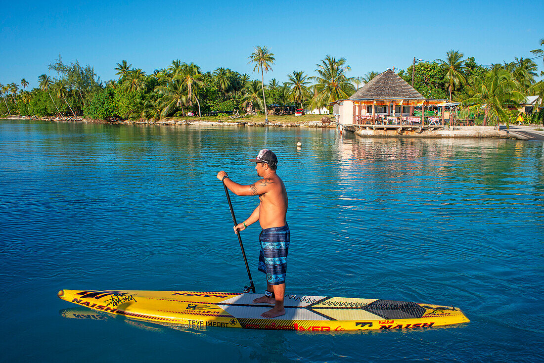 Paddle surf in the beach of Rangiroa, Tuamotu Islands, French Polynesia, South Pacific.