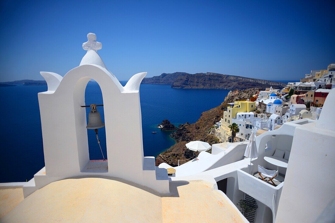 Church bell and hillside buildings in Oia, Santorini, Greek Islands, Greece