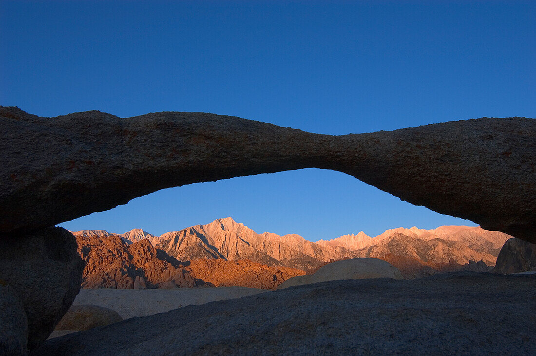 Lone Pine Peak and Whitney Portals at sunrise, seen through Lathe Arch in the Alabama Hills; eastern Sierra Nevada Mountains, California.