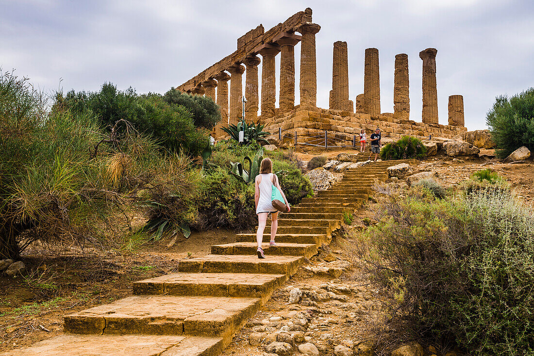 Tourist sightseeing at Valley of the Temples (Valle dei Templi), Temple of Juno (Tempio di Giunone), Agrigento, Sicily, Italy, Europe. This is a photo of a tourist sightseeing at The Temple of Juno (Tempio di Giunone) at The Valley of the Temples (Valle dei Templi), Agrigento, Sicily, Italy, Europe.