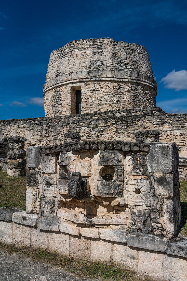 A Chaac Mask on the Temple of the Chaac Masks in front of the Round Temple or Observatory in the ruins of the Post-Classic Mayan city of Mayapan, Yucatan, Mexico.