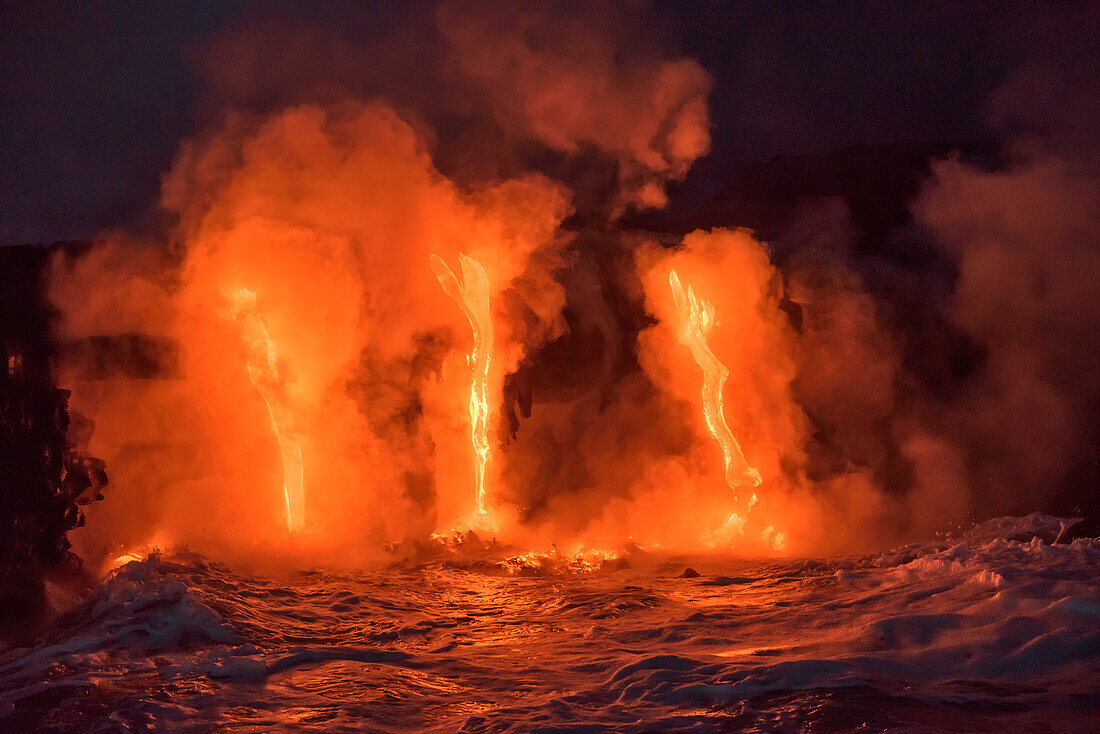 Lava from Pu'u O'o eruption flowing into ocean on the Kalapana coast, Hawaii Volcanoes National Park, Big Island of Hawaii.