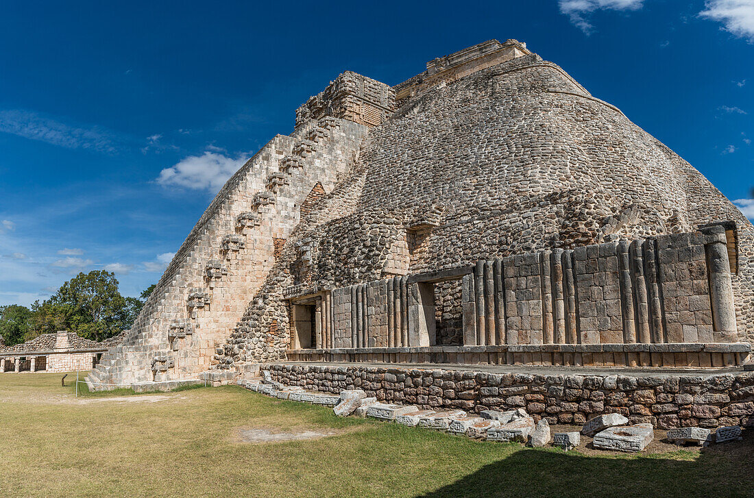 The west side of the Pyramid of the Magician faces the Quadrangle of the Birds in the ruins of the Mayan city of Uxmal in Yucatan, Mexico. Pre-Hispanic Town of Uxmal - a UNESCO World Heritage Center.