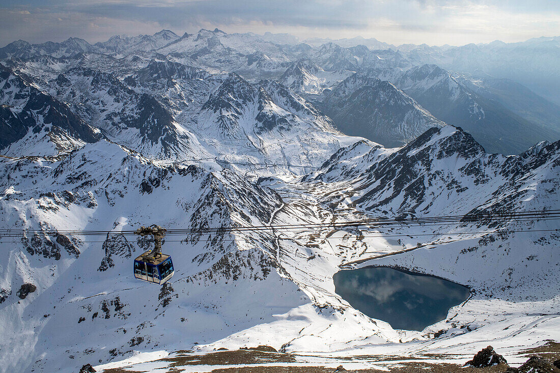 La Mongie lake of Oncet and a cable car rising to The Observatory Of Pic Du Midi De Bigorre, Hautes Pyrenees, Midi Pyrenees, France