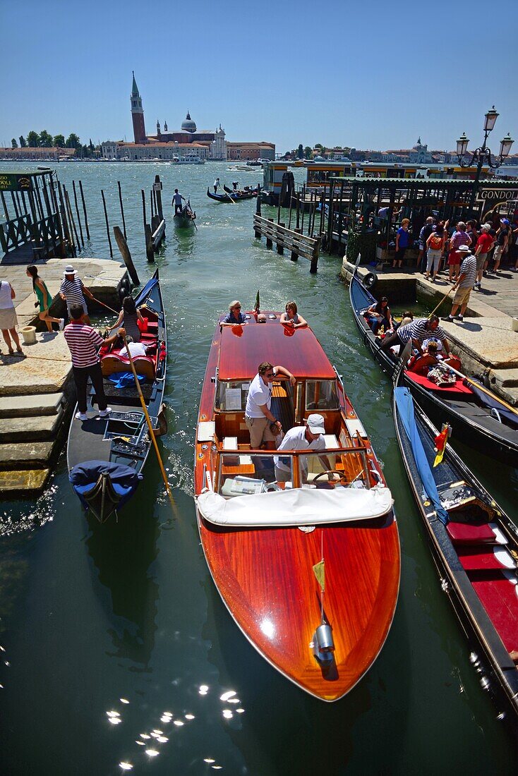 Boats and gondolas in the canals of Venice, Italy