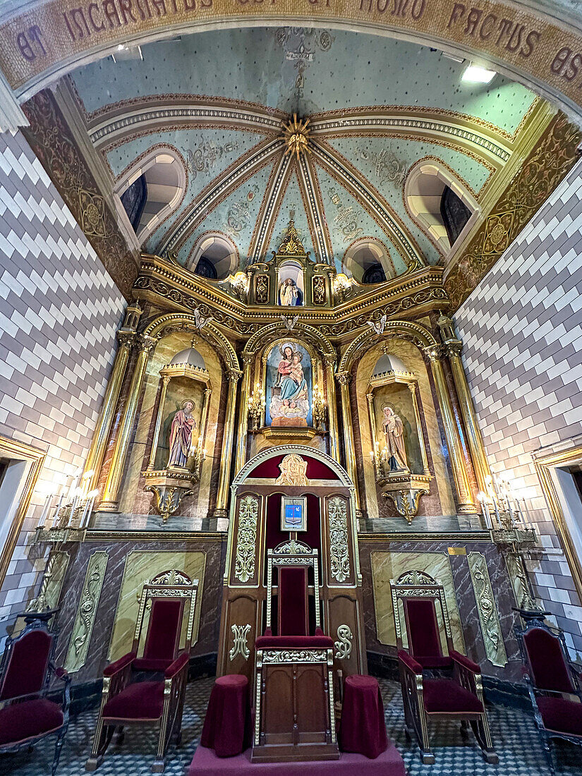 The cathedra or bishop's chair & main altarpiece in the apse of Our Lady of Loreto Cathedral, Mendoza, Argentina.