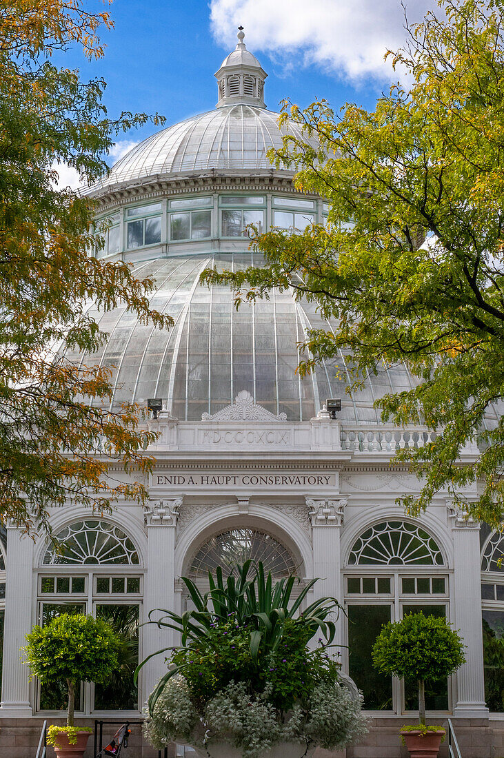 Enid A. Haupt Conservatory and pond with water lilies Greenhouse, New York Botanical Garden, Bronx, New York City, New York State, USA.