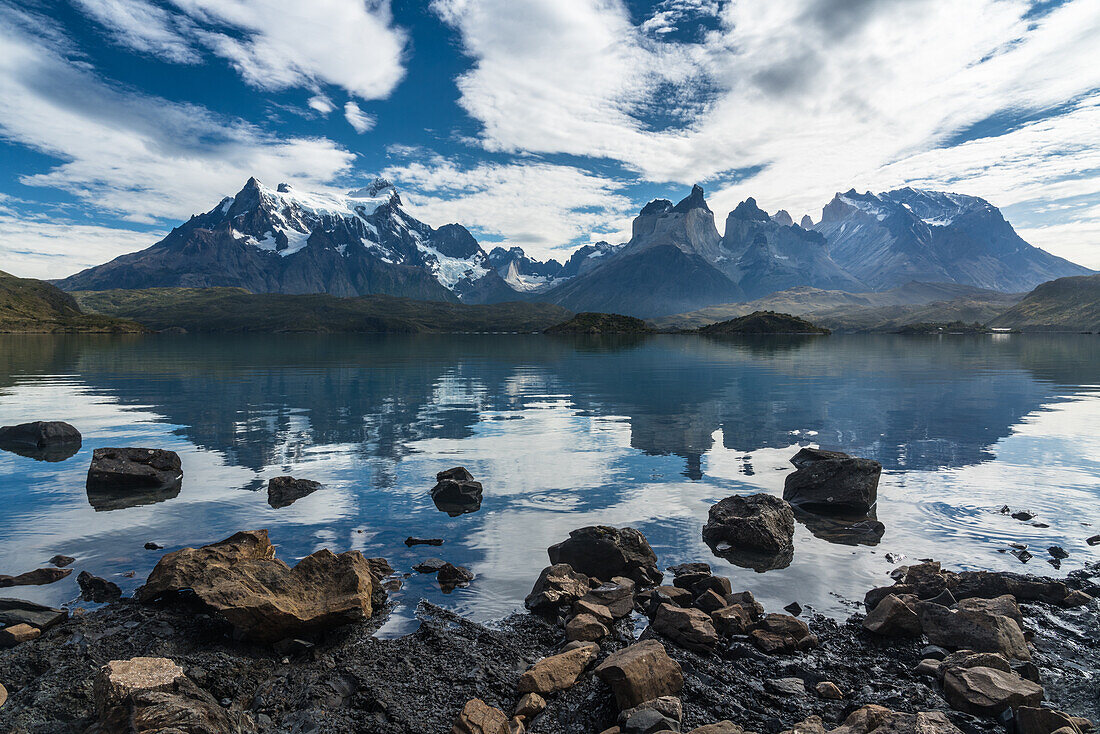 Early morning reflections of the Paine Massif in Lago Pehoe in Torres del Paine National Park, a UNESCO World Biosphere Reserve in Chile in the Patagonia region of South America.