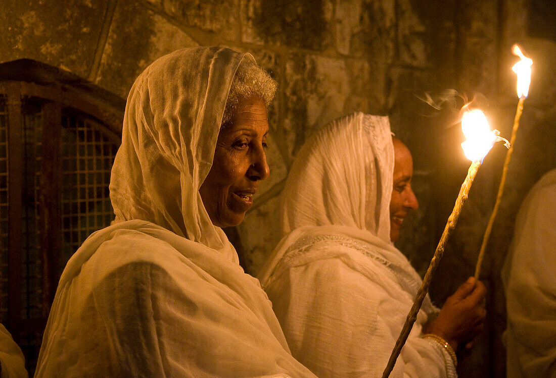Ethiopian Orthodox worshipers hold candeles during the Holy fire ceremony at the Ethiopian section of the Holy Sepulcher in Jerusalm Israel