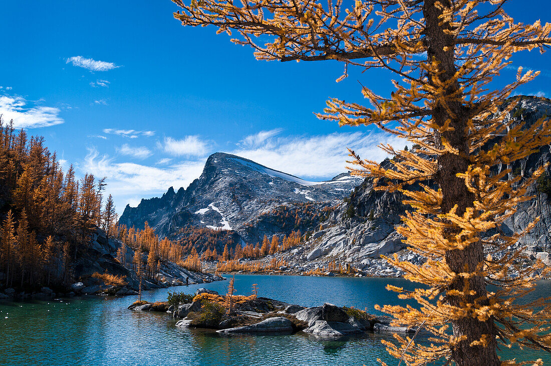 Perfection Lake and Little Annapurna mountain with alpine larch trees showing autumn color in The Enchantments, Alpine Lakes Wilderness, Washington.