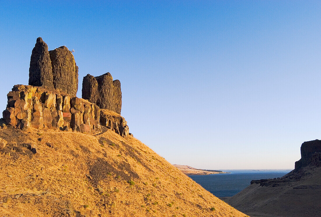 The Sisters basalt rock formation, a scab residual of the Missoula Floods on the east bank of the Columbia River at the Wallula Gap in southeast Washington. In Cayuse Indian legend Coyote turned two sisters into the stone pillars.
