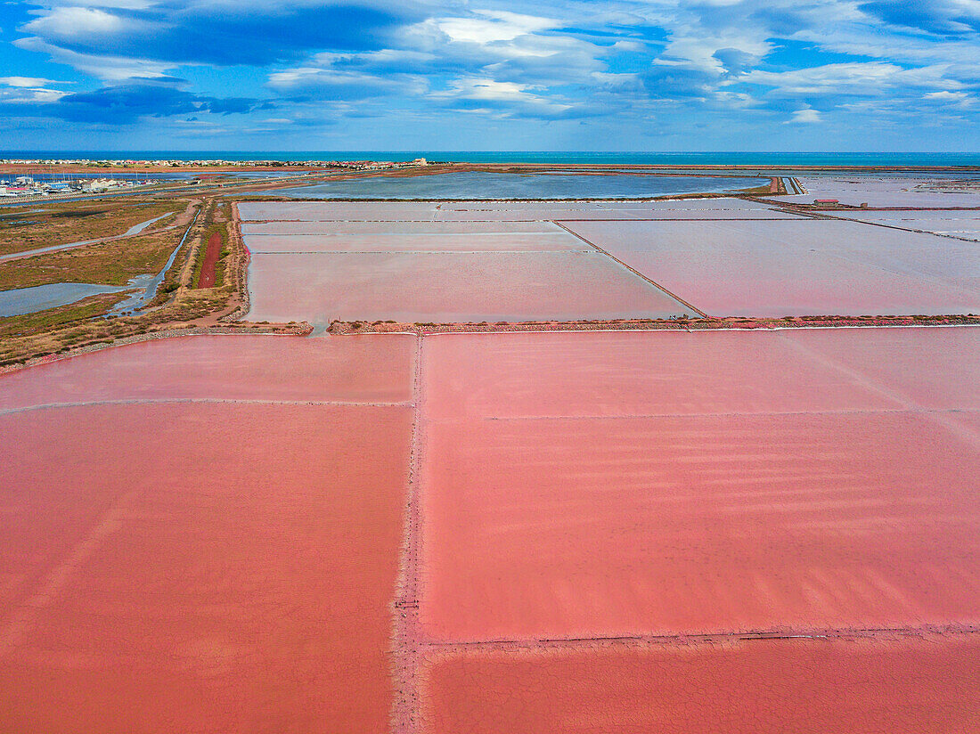 Salt production of Salins du Midi at Gruissan in Languedoc-Roussillon, France, Aude, Gruissan. Solar evaporaton salt pans salins. salt marshes, saline of Gruissan in aerial view.